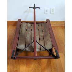 a wooden bed frame with a cross on top and two swords sticking out of it