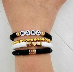 This is a super cute and fun stack of bracelets accented with black and gold heishi beads you are sure to love. Personalize with a name or names of your choice add a heart or filler bracelet to complete your stack! Great gift for any women or girls! Give mama a gift for Mother's Day! You may choose to have a single name bracelet 1 single filler bracelet or if choosing multiple bracelets, you can choose 2 names or 1 name and a filler or 3 names if choosing 3 bracelets and so on. How to order 1) S Momma Clay Bead Bracelet, Mom Heishi Bracelet, Stacked Heishi Bracelets, Mother’s Day Diy Bracelets, Clay Bead Bracelet Ideas Mama, Mama Heishi Bracelet, Mothers Day Clay Bead Bracelet Ideas, Clay Bead Bracelets For Moms, Clay Bead Stack Ideas