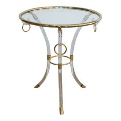 a glass and metal table with gold accents