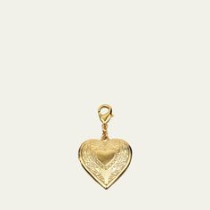 Heart shaped locket charm by Ben-Amun. 24-karat gold electroplating. Engraved floral and heart detail. Approx. 1.75"L x 1.125"W. Lobster claps. Made in USA. Gold Heart Charm Pendant, Heart Pendant Jewelry With Logo Charm As Gift, Heart Pendant Jewelry With Logo Charm For Gifts, Gold Vintage Charm Heart Pendant, Gold Heart Pendant Vintage Charm, Gold Double Heart Charms Gift, Vintage Gold Heart Pendant Charm, Gold Double Heart Charms For Gifts, Gold Vintage Heart Pendant Charm