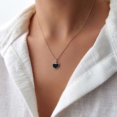 This elegant black heart necklace is crafted with 14k solid gold, embodying timeless beauty and sophistication. Its minimalist design, combined with the finest craftsmanship, makes it a perfect piece for everyday wear or a meaningful gift for a loved one. This necklace is crafted with real 14k solid gold(not plated, not vermeil, not gold filled) You don't need to worry about water, perfume or conditioner contact since real gold doesn't tarnish. The center is hand applied black enamel on top of solid gold for the design purpose, hot applied enamel is the best and most resistant type of application in which enamel and gold bond together over extreme temperatures. This ensures that your piece keeps its beauty for decades to come. You can even wear this piece in water as well. Minimalist Heart Cut Jewelry With Polished Finish, Minimalist Heart Cut Polished Jewelry, Elegant 14k Gold Necklace With Black Enamel, Elegant Black Enamel 14k Gold Necklace, Minimalist 14k Gold Necklace With Heart Charm, Black Enamel 14k Gold Necklace, Minimalist Tarnish Resistant 14k Gold Heart Necklace, Minimalist 14k Gold Double Heart Necklace, Black Sterling Silver Tarnish Resistant Necklace