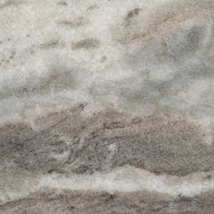 a close up view of a marble counter top with brown and white streaks on it