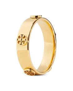 Tory Burch Miller Logo Studded Band Ring in 18K Gold Plated Designer Gold Jewelry With Gold-tone Hardware, Designer Yellow Gold Jewelry With Gold-tone Hardware, Designer Yellow Gold Jewelry With Logo, Timeless Yellow Gold Jewelry With Logo Plaque, Timeless Yellow Gold Jewelry, Timeless Yellow Gold Jewelry With Gold-tone Logo, Gold Jewelry With Logo For Anniversary, Gold Jewelry With Gold-tone Logo Plaque For Anniversary, Gold-tone Logo Plaque Jewelry For Anniversary