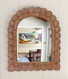 a mirror hanging on the wall above a table