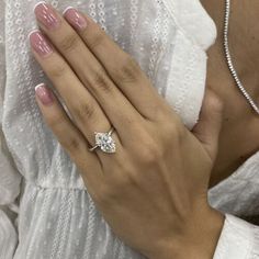 a woman's hand with a diamond ring on it