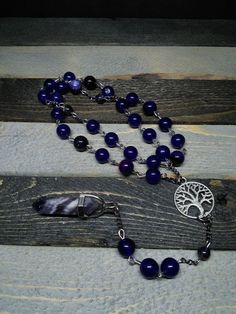 This is a beautiful re-imagined rosary based on the classic Catholic rosary.  The  beads are amethyst.  There are three decades of nine beads each.  The center is a tree of life, and I have capped it off with a amethyst pendent which can double as a spirit guide pendulum.  With this rosary I'm including a simple chant which has resonated with me, but feel free to use your own!   Pagan/witch prayer chant: Knot one, the work's begun. Knot two, my aim is true. Knot three, it will be. Knot four, pow Spiritual Rosary With 108 Beads And Crucifix, Spiritual Round Beads Rosary For Jewelry Making, Spiritual Beaded Rosary For Jewelry Making, Bohemian Rosary With 108 Beads For Healing, Bohemian Rosary Bracelet With 8mm Beads For Meditation, Handmade Spiritual Healing Rosary, Spiritual Gemstone Beads Rosary, Spiritual Rosary With 8mm Beads, Spiritual Rosary With 8mm Beads For Healing