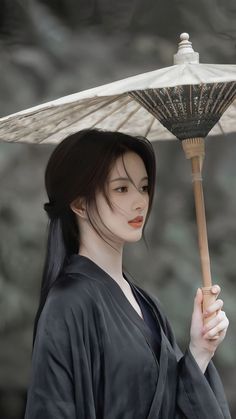 a woman holding an umbrella over her head