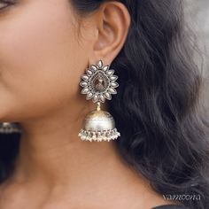 Enhance your look with Mayura jumkis, featuring an elegant oxidized finish complemented by rich 22kt gold plating. These earrings merge classic charm with a contemporary edge, offering a sophisticated accessory that stands out with every wear. Fusion Style Chandbali Brass Jhumkas, Fusion Style Jhumkas With Latkans For Celebration, Elegant Brass Jhumkas With Tilla, Elegant Brass Tilla Jhumkas, Elegant Antique Finish Earrings For Festive Occasions, Traditional Oxidized Finish Earrings For Formal Occasions, Navratri Chandbalis With Oxidized Finish, Gold Earrings With Oxidized Finish For Festive Occasion, Festive Gold Earrings With Oxidized Finish