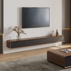 a living room with a large flat screen tv mounted on the wall next to a wooden coffee table