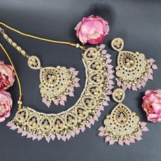 Elevate your elegance with our exquisite Baby Pink Indian Asian Bollywood Jewelry Set. This captivating bridal choker fashion necklace, paired with stunning earrings and a delicate tikka, exudes timeless charm fit for a wedding or any special occasion. Crafted with precision, this set showcases intricate detailing and the delicate hue of baby pink, adding a touch of ethereal beauty to your ensemble. Designed to complement the grace of women, this jewelry set is more than adornment; it's an expre Pink Bridal Necklace With Matching Earrings For Wedding, Pink Wedding Necklaces With Matching Earrings, Pink Necklaces With Matching Earrings For Wedding, Elegant Pink Bridal Sets For Party, Pink Hand Set Bridal Necklace For Party, Pink Hand-set Bridal Necklace For Party, Pink Dangle Necklaces For Wedding, Hand Set Jewelry Sets For Wedding, Pink Elegant Jewelry For Wedding