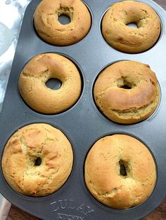 six muffins in a pan on top of a wooden table