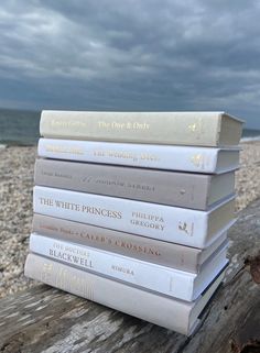 a stack of books sitting on top of a wooden log