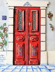 a red door is painted on the side of a building