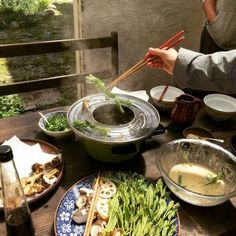 a table topped with lots of plates and bowls filled with different types of food on top of it