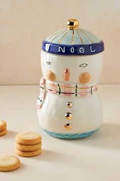 a cookie jar and cookies on a table