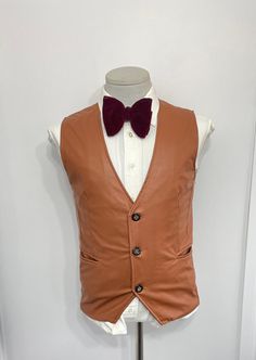 "Vintage Victoria ultra leather brown western vest/waistcoat. This suit vest waistcoat features 3 button closure and two jetted hip pockets.  Fit in with any clothing. A great grab for vintage enthusiast Estimated size: 36   :Please see measurement below , for best fit compare measurement with similar vest waistcoat or item. Armpit to Armpit:18.50\" Front Length: 23.50\" Condition: for its age, its in a  Pre-owned and in a well-off-taking care condition. However, there is slight loose thread on Formal Brown Sleeveless Outerwear, Brown Sleeveless Formal Outerwear, Fitted Brown Vest With Button Closure, Brown Vest With Button Closure For Work, Brown Business Vest For Fall, Brown Single Breasted Vest For Winter, Brown Single-breasted Vest For Winter, Formal Brown Vest With Buttons, Brown Buttoned Vest For Formal Occasions