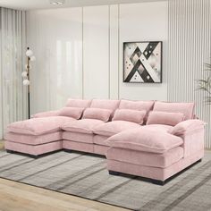 a living room with a large pink sectional couch