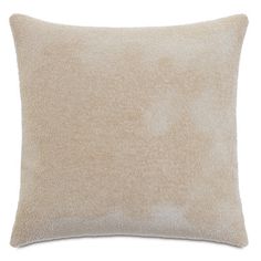 a beige pillow on a white background