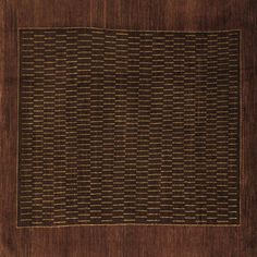 a brown and black area rug with squares on it