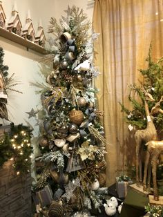 a christmas tree is decorated with silver and gold ornaments