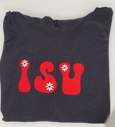 Put a new spin on the basic college hoodie.  Fun groovy letter embroidery on T-shirts, crewneck sweatshirts or hoodies with flowers.   Pick your letters and thread colors, up to 6 for a unique, custom sweatshirt. More letters can be done on request. Unisex sizes. Available in crewneck or hoodie.  99% of the T-shirts and sweatshirts are Gildan brand heavy weight cotton/polyester.  Occasionally an equivalent brand will be used.  As these are custom made please allow time for them to be made. If yo Casual School Tops With Embroidered Logo, Casual Tops With Embroidered Logo For School, College Cotton Hoodie With Screen Print, Cotton College Hoodie With Screen Print, Cotton Hoodie With Screen Print For College, Casual Hoodie With Embroidered Graphics For College, Casual College Hoodie With Embroidered Graphics, Spring School Spirit Cotton Sweatshirt, Spring Cotton Sweatshirt With School Spirit