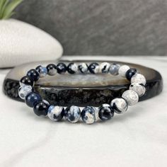 "Polished beads made from orca agate (thought to be a variety of blue chalcedony). 8mm Bracelets Sized: 6.50\" - 6.75\" Our crystals and minerals are natural, and some are shaped by hand. Because each is unique and one of a kind, some may come with small chips or imperfections. Any appearances of cracks are one of the natural characteristics of this crystal or mineral and not because of damage. We select all crystals and minerals by hand. We choose the most unique and highest quality we can find Casual Agate Beaded Bracelets With Gemstone Beads, Casual Agate Gemstone Beaded Bracelets, Adjustable Casual Agate Stretch Bracelet, Casual Adjustable Agate Stretch Bracelet, Casual Agate Beaded Bracelets With Round Beads, Casual Agate Beaded Bracelets, Casual Round Agate Beaded Bracelets, Casual Hand-strung Agate Bracelet, Casual Black Agate Beaded Bracelets