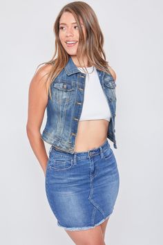 It’s giving biker babe! Our Women’s Vintage Denim Vest is the perfect 90’s throwback mixed with some edginess. We’ve designed this vest with special treatments and fading to embody the look of denim in the 90’s. This vest also has a fitted and cropped silhouette. Featuring a 6-button front closure with 2 front patch pockets. For a 90s look, pair with denim jeans and platform sneakers. For a more modern take, pair this vest with a black mini skirt and tall black boots!Product Details- 5-Button Closure- 2 Front Flap Pockets- FadingSize & Fit (based on size M)- Length: 19”- Chest: 17"- Model is wearing a size SMachine wash cold.Tumble dry low.66% Cotton/ 27% Polyester/ 6% Rayon/ 1% Spandex (Color: J200 Medium Blue) Dark Wash Denim Vest With Frayed Hem, Trendy Medium Wash Vest, Trendy Fitted Denim Blue Vest, Fitted Trendy Denim Blue Vest, Trendy Fitted Medium Wash Vest, Fall Medium Wash Denim Vest, Fitted Trendy Medium Wash Vest, Denim Blue Denim Vest With Frayed Hem, Denim Blue Frayed Hem Denim Vest