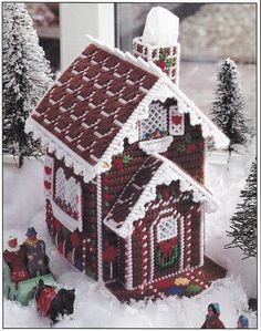 a gingerbread house is shown in the snow