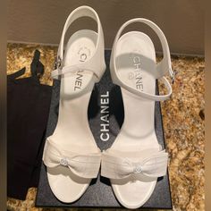 Hello!!! I Hope You Will Love These Shoes As Much As I Did When Purchasing Them! I Have Never Worn This Shoes Other Than For Pictures At My House For About 10 Mins For My Wedding Day!! These Are Brand New Chanel Bow White Sandal Heels!! I Bought These At The Wynn Las Vegas Chanel Boutique! They Are So Special To Me But They Are Too High For Me So I Want To Sell Them! If You Have Any Questions Please Let Me Know!! All Original Packaging Of The Box. These Are Perfect Shoe To Have In Your Collectio Wedding Heels Chanel, White Heels Chanel, Wedding Heels Luxury, Chanel White Heels, Classy White Heels, Luxury High Heel Summer Heels, Luxury White Open Toe Heels, Luxury White Block Heel Sandals, Designer White Sandals With Heel Strap