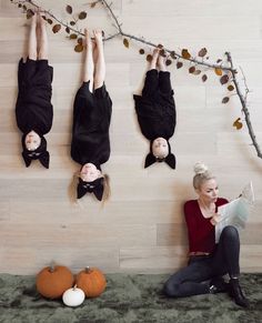 three people are hanging upside down on the wall