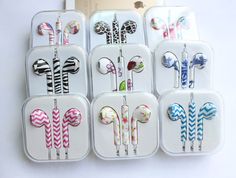 there are many earphones in the case on this table and one is pink, blue, green, white