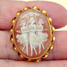 "This Lovely Antique Cameo is a hand carved conch shell, brooch, measuring 1 1/4\" x 1\". It is in excellent condition, and has a fine 10k Gold Setting. The subject of this piece is one of my favorites, 'The Three Graces: Splendor, Mirth and Good Cheer, who were minor goddesses in Greek Mythology: representing beauty, nature, charm, creativity, and fertility. Hand carving conch shell is a very old tradition, that is still practiced in Italy today, the skill handed down from generation to generat Lego Sculptures, Three Graces, Cameo Jewelry, Carved Shell, Good Cheer, Cameo Brooch, Conch Shell, Gold Jewelry Fashion, Greek Mythology