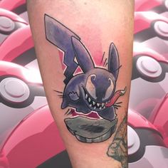 a cartoon tattoo on the leg of a person with an evil bunny face and teeth