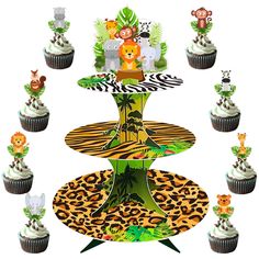 cupcakes are arranged in the shape of a tiered cake stand with jungle animals on it