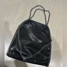 Brand New Gorgeous Black Vegan Leather Oversized Handbag! This Style Is Back And We Are Living For It! Zips Closed So Your Items Stay Inside Has Small Inside Pocket For Keys And Cards Or Small Items. Very Versatile Everyday Shoulder Bag Black Zipper, And Gunmetal Hardware Hard Stitching All Around The Sides Of The Bag Looks Just Like The Falabella Bag By Stella! This Is A Boutique Purchase, Amazing Quality Will Come With A Plain White Dust Bag For Storage And Safe Keeping Of Your New Purse! You Can Go Clean Girl Aesthetic Or Punk Rock With This Bag, This Bag Was Ironic In Early 2000s And Is Coming Back Again And Re-Released Recently! Any Questions Just Ask! Usa Ship Only Open To Black Tote Bag With Chain Strap, Black Satchel Bag With Chain Strap, Black Shoulder Bag With Chain Strap And Top Handle, Black Top Handle Shoulder Bag With Chain Strap, Top Handle Bag With Chain Strap For Night Out, Leather Top Handle Bag For Night Out, Shopping Tote Bag With Chain Strap, Black Satchel With Chain Strap For Travel, Black Travel Satchel With Chain Strap