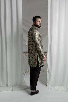 Upgrade your style with our Black and Gold Prince Coat. Made from luxurious brocade material, this front open coat exudes royalty. Paired with an Indian raw silk kurta pajama, it's the perfect ensemble for any formal event. Elevate your look and make a statement with this unique and elegant piece. 3-Piece Suit Designer Silk Fitted Outerwear, Fitted Silk Outerwear, Designer Straight Kurta Bandhgala For Ceremonial Occasions, Designer Ceremonial Bandhgala With Straight Kurta, Festive Designer Nehru Jacket With Stand Collar, Designer Nehru Jacket With Zari Work For Festive, Designer Festive Nehru Jacket With Zari Work, Elegant Traditional Drape Outerwear For Party, Elegant Party Outerwear With Traditional Drape