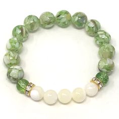 Precious looking green peridot & mother of pearl gemstones bracelets • elegant, simple and meaningful! Known as the stone of compassion, peridot is believed to bring good health, restful sleep and peace to relationships by balancing emotions and mind. Mother of Pearl offers protection, brings the gentle healing power of the sea. It is a stress relieving stone; relaxing, soothing and calming to the emotions. The 2 piece set includes: 1x 8mm green peridot with natural shell bracelet 1x 8mm mot Gemstones Bracelets, Bracelets Elegant, Balancing Emotions, Green Beaded Bracelets, Healing Gemstone Bracelets, Fusion Beads, Green Bracelet, Wrist Candy, Shell Bracelet