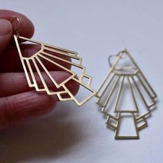 These gold tone Art Deco earrings are quintessentially modernist: geometric straight lines with the architectural spirit of the age.

 	Lightweight laser-cut pendants are statement-sized at 2" long by 1 1/2" wide.
 	Also available in silver tone on 925 sterling silver earring wires.
 	These earrings only available in French loops.

Dress these up or down. Expect compliments.

Shop more Art Deco at minusOne.

Learn more about Modernist Art Deco jewelry and the spirit of the Art Deco era on the mi Modern Metal Jewelry With Artistic Design, Modern Geometric Gold Jewelry, Modern Geometric Jewelry With Unique Design, Gold Sterling Silver Earrings With Artistic Design, Modern Geometric Gold Earrings, Modern Gold Geometric Earrings, Gold Geometric Brass Jewelry, Modern Rectangular Brass Earrings, Modern Laser Cut Jewelry For Gifts