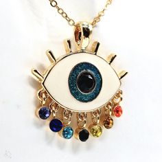 Add Some Bohemian Charm To Your Jewelry Collection With This Beautiful Eye-Catching Pendant Necklace From Harleyscrazedcreations. The Necklace Features A Colorful Evil Eye Ball With Rainbow Tear Drop Lashes, Adding A Touch Of Art And Beauty To Your Outfit. The Pendant Is Made Of Enamel And Glass, Iron, And Zinc Alloy. The Lobster Closure And Adjustable Features Ensure That The Necklace Fits Comfortably Around Your Neck. With Seven Gemstones And A Glass Main Stone, This Necklace Is Perfect For Th Colorful Evil Eye, Eye Ball, Tear Drops, The Lobster, Beautiful Eye, Jewelry Accessories Ideas, Accessories Ideas, Healing Powers, Tear Drop