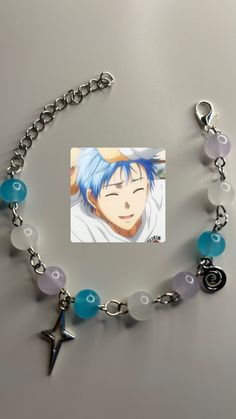 an anime character with blue hair is shown on a bracelet