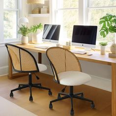 two computer desks sitting next to each other on top of a hard wood floor