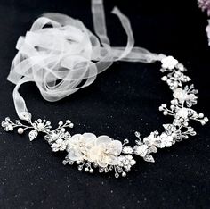 Add a touch of classic elegance to your bridal gown with this beautiful floral belt! Adorned with silk flowers embellished with glowing crystals and pearls on a silver base, it will give your dress an extra touch of glam to finish off your perfect look on your wedding day. The floral appliqué measures approx. 12.5" long (approx. 31.7cm) by 2" wide (approx. 5cm). It can be ordered as appliqué only, attached to your choice of white or ivory double-faced satin ribbon, or white or ivory organza ribb Belt For Wedding Dress, Bridal Sash Belt, Wedding Dress Belt, For Wedding Dress, Bridal Sash, Romantic Design, Bridal Belt, Organza Ribbon, Sash Belt