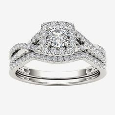 a white gold ring with two rows of diamonds on the band and a center diamond in the middle