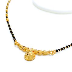 Weighing 11.0 grams, this 22k gold thali mangal sutra embodies classic allure with its timeless design. The black bead accents provide a striking contrast to the yellow gold finish, creating a piece that is both elegant and traditional. The 16-inch necklace length ensures a comfortable fit, while the 0.25-inch drop adds a subtle yet stylish detail. With a secure hook lock, this mangal sutra blends cultural significance with sophisticated charm, making it a perfect symbol of marital unity and tim 1tola Gold Mangalsutra, Aagri Koli Mangalsutra, Wati Mangalsutra Designs Gold, Luxury 22k Gold Traditional Mangalsutra, Brass High Gold Mangalsutra, Mangal Sutra, 22k Gold Bangles, 16 Inch Necklace, Lock Style