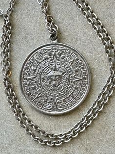 Sterling silver vintage Mexican Myan Calndar  Sun pendant medallion necklace Chain measures about 20 inches around Ornate Medallion Jewelry With Coin Pendant, Ornate Medallion Coin Pendant Jewelry, Silver Etched Pendant Necklace, Silver Sterling Medallion Necklace, Antique Silver Medallion Necklace In Sterling Silver, Antique Silver Medallion Stamped 925 Jewelry, Symbolic Antique Silver Necklace Stamped 925, Silver Sterling Silver Medallion Necklace, Vintage Silver Medallion Jewelry