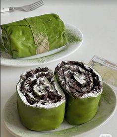 there are two green rolls on the plate