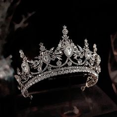 a tiara is displayed on a black surface