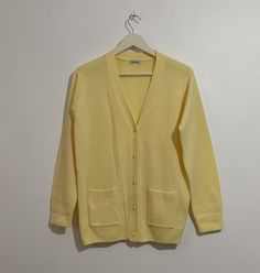 Lovely vintage 80s/90s lemon yellow chic granny cardigan! 🌼 In the CUTEST fresh pale pastel lemon baby yellow shade! 💛 Long sleeved with a V-neck button-up front, slightly longer length, ribbed cuffs & hem and 2 front pockets. Great layering piece! Throw over any outfit for cute chic vibes this springtime! 🍋 Check out my other jumpers- I have loads of lush knitwear in a variety of fab colours! 🌈 Brand- DAMART Labelled size small 10/12. Would fit sizes 6 8 10 12 depending on desired fit. Meas Cheap Yellow Vintage Sweater, Classic Yellow Sweater For Spring, Yellow Sweater With Button Closure For Spring, Classic Yellow Long Sleeve Cardigan, Classic Yellow Winter Cardigan, Yellow Buttoned Sweater For Spring, Yellow Button Sweater For Spring, Spring Yellow Buttoned Cardigan, Yellow Casual Cardigan With Buttons