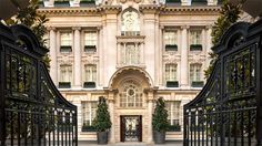 the entrance to an ornate building with wrought iron gates and gated entry way leading into it