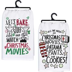 two towels with christmas movies on them hanging from clothes hooks, one in white and the other in green